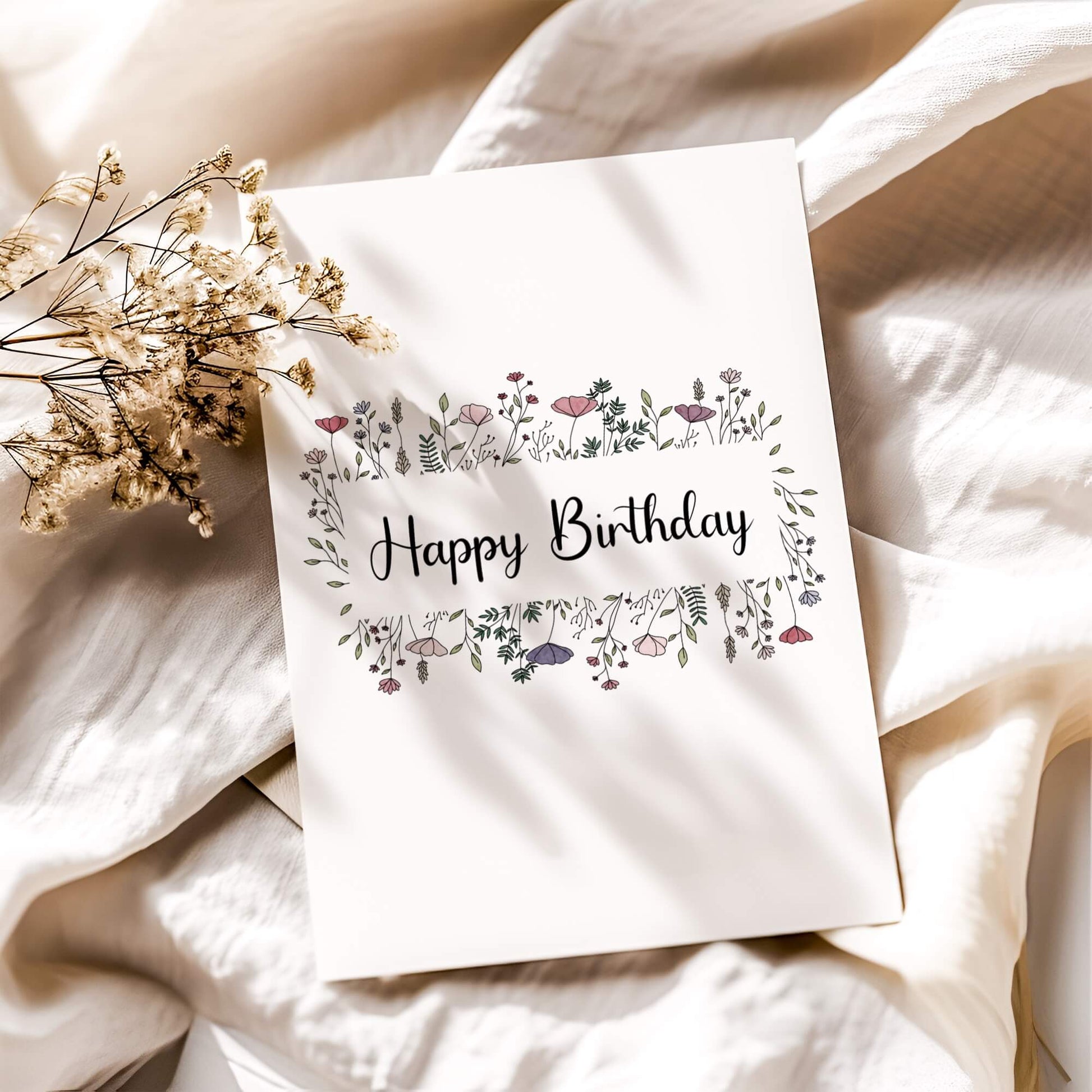 Minimalist floral birthday card with delicate pink wildflowers and modern calligraphy on white linen background with dried baby's breath. Digital printable birthday greeting card in botanical style